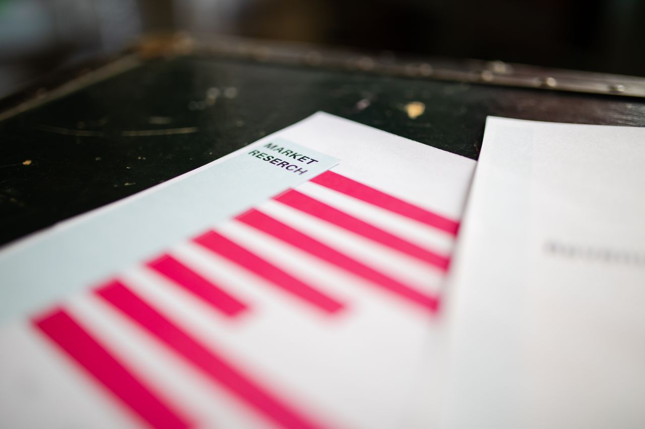 about-01 A detailed close-up of a market research document featuring a bar graph and a focus on market trends.